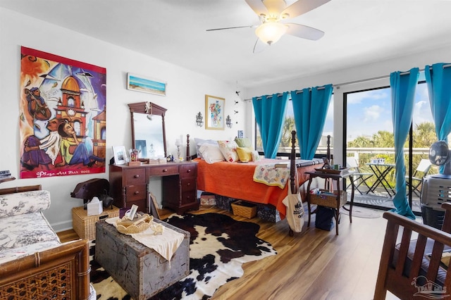 bedroom featuring access to outside, ceiling fan, and wood finished floors