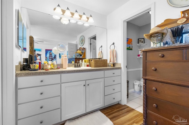 bathroom with vanity, wood finished floors, and toilet