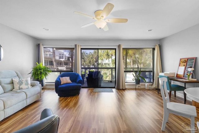 living area with a healthy amount of sunlight, a ceiling fan, recessed lighting, and wood finished floors