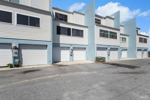 exterior space with central AC unit and stucco siding
