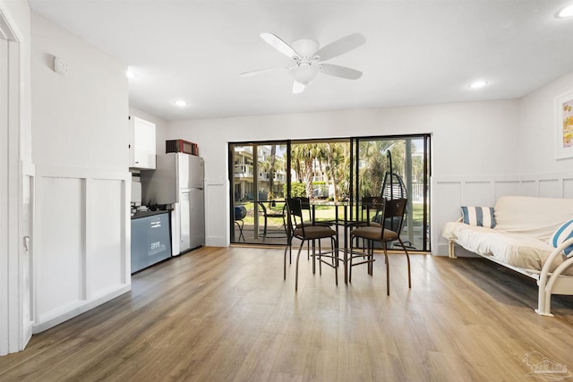 dining room with a decorative wall, recessed lighting, ceiling fan, and light wood-type flooring