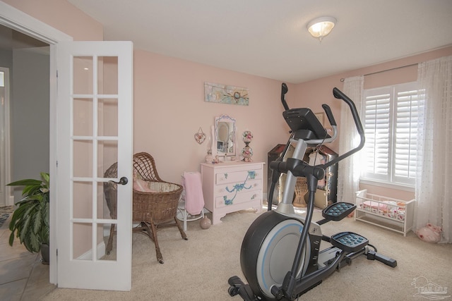 exercise area with light carpet and french doors