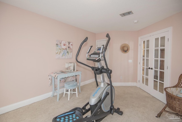 exercise area with light colored carpet and french doors