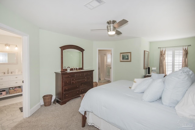 carpeted bedroom with ceiling fan, connected bathroom, and sink