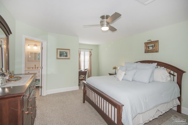 carpeted bedroom with ceiling fan, sink, and connected bathroom