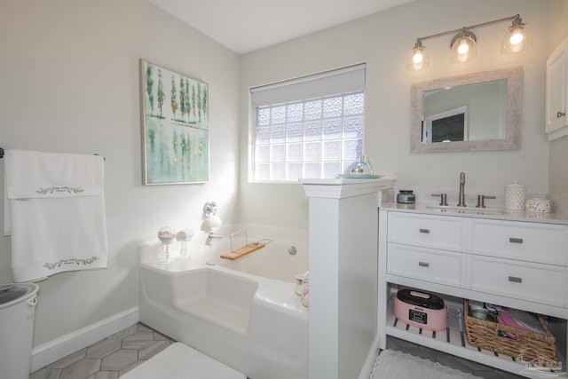 bathroom featuring a tub to relax in, vanity, and tile patterned flooring