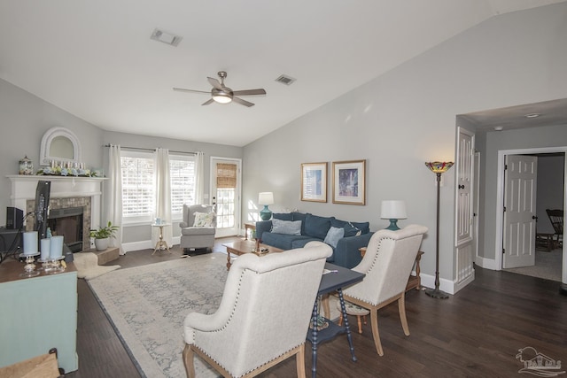 living room featuring ceiling fan, a fireplace, dark wood-type flooring, and vaulted ceiling