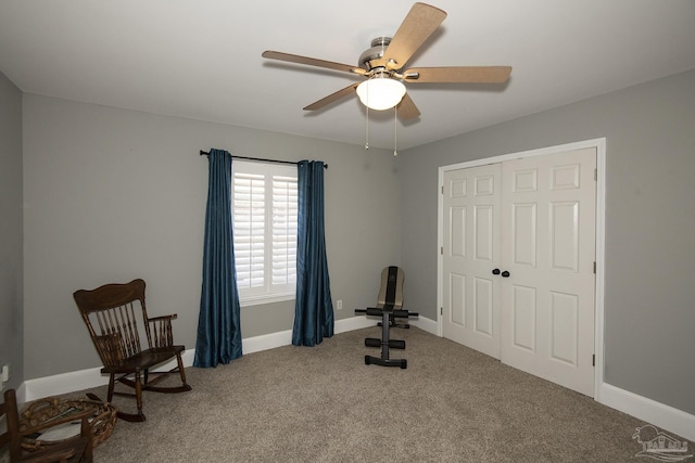 sitting room featuring ceiling fan and carpet flooring