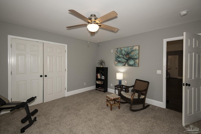 living area featuring ceiling fan and carpet flooring