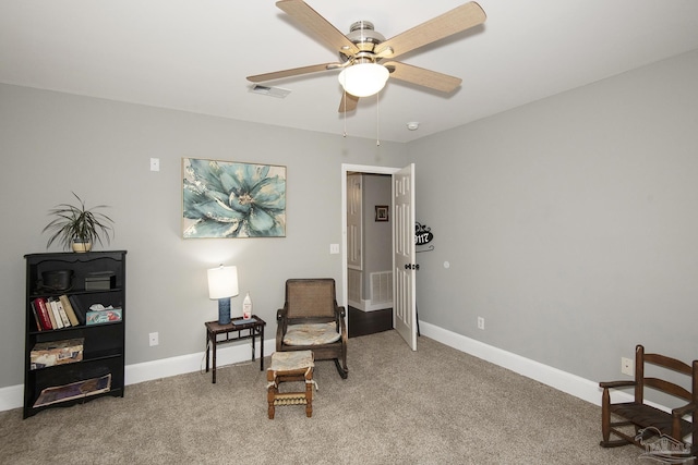 living area with carpet and ceiling fan