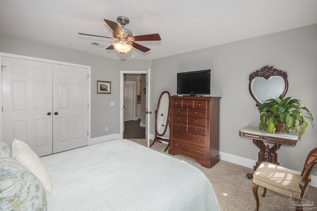 carpeted bedroom with ceiling fan and a closet