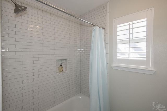 bathroom with shower / bath combo with shower curtain