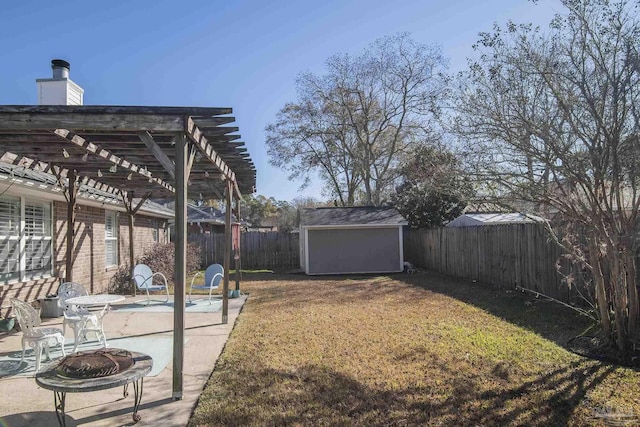 view of yard with a patio area, a storage shed, a fire pit, and a pergola