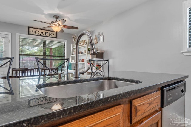 1841 E Smugglers Cove Dr, Gulf Breeze, FL 32563 - kitchen with stainless steel dishwasher, a sink, brown cabinetry, and plenty of natural light