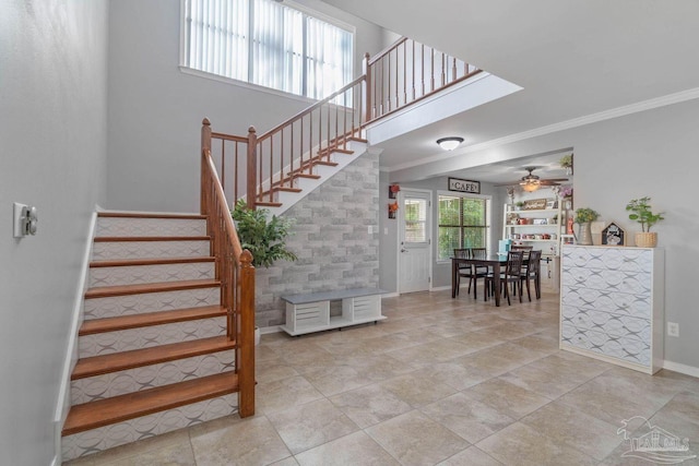 1841 E Smugglers Cove Dr, Gulf Breeze, FL 32563 - staircase with ceiling fan, baseboards, and crown molding