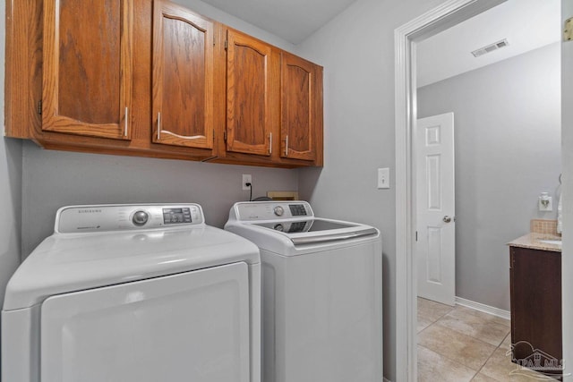1841 E Smugglers Cove Dr, Gulf Breeze, FL 32563 - laundry room featuring washing machine and dryer, cabinet space, and baseboards