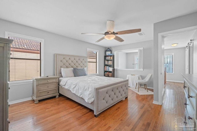 1841 E Smugglers Cove Dr, Gulf Breeze, FL 32563 - bedroom featuring light wood-type flooring, baseboards, and a ceiling fan