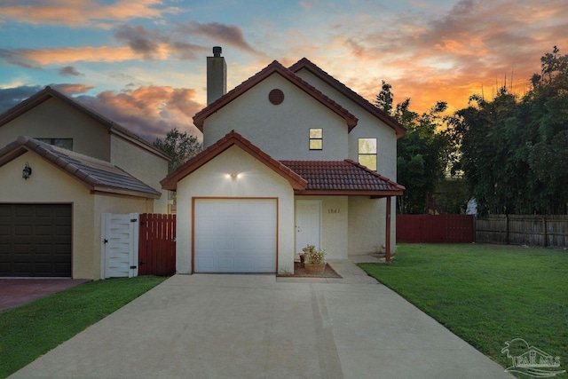 1841 E Smugglers Cove Dr, Gulf Breeze, FL 32563 - view of front facade featuring a tiled roof, a chimney, stucco siding, concrete driveway, and a gate