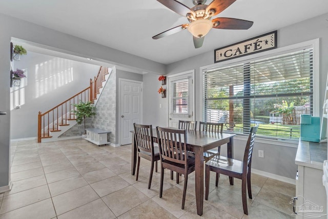 1841 E Smugglers Cove Dr, Gulf Breeze, FL 32563 - dining area featuring baseboards, stairway, a ceiling fan, and light tile patterned flooring