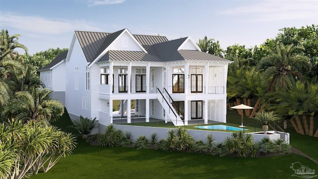 back of property with a balcony, stairway, a standing seam roof, metal roof, and a lawn