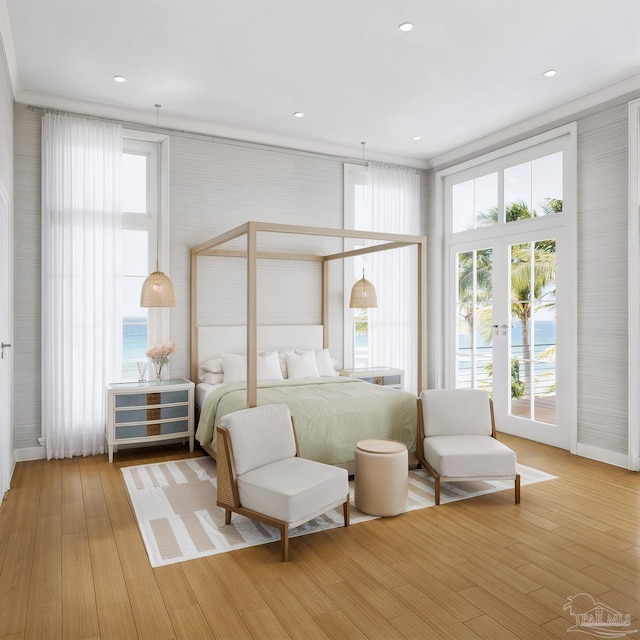 bedroom with access to outside, light wood-style flooring, multiple windows, and baseboards