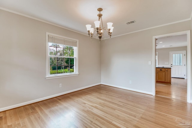 empty room featuring baseboards, visible vents, crown molding, and light wood finished floors