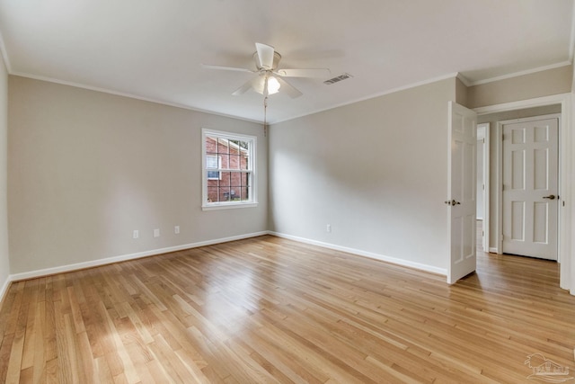 spare room featuring baseboards, visible vents, and light wood-style floors