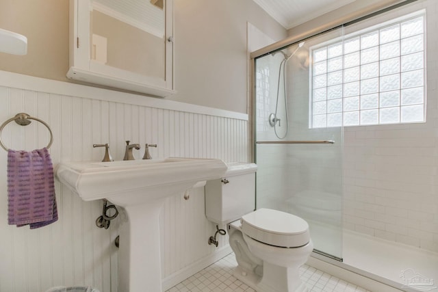 1775 E Texar Dr, Pensacola, FL 32503 - full bath with toilet, a shower stall, tile patterned floors, and wainscoting