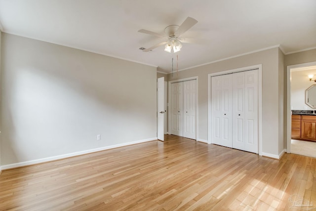 1775 E Texar Dr, Pensacola, FL 32503 - unfurnished bedroom featuring light wood-style flooring, multiple closets, baseboards, connected bathroom, and crown molding