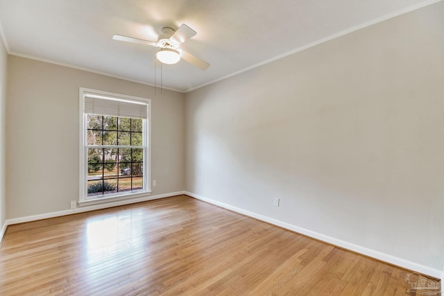 empty room featuring ornamental molding, a ceiling fan, baseboards, and wood finished floors