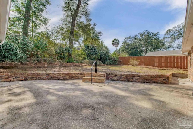 view of yard with fence and a patio