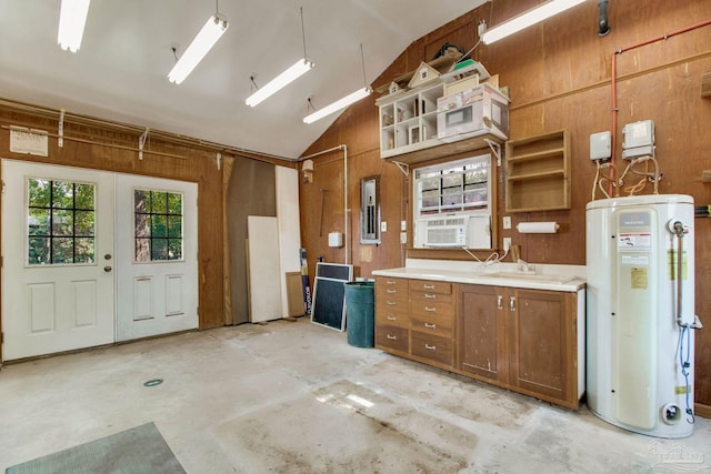 garage featuring electric panel, water heater, a sink, and wooden walls