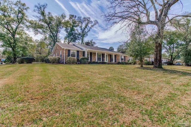 single story home featuring a front yard and brick siding