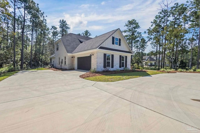 view of property exterior featuring a garage and a lawn