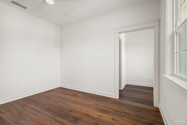 spare room featuring ornamental molding, dark wood-type flooring, and ceiling fan