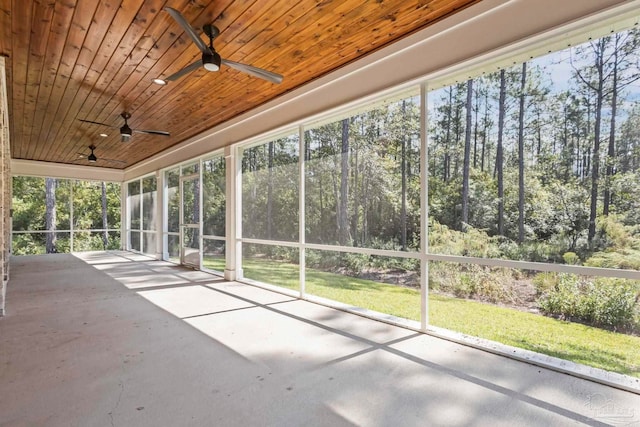 unfurnished sunroom with wood ceiling and ceiling fan