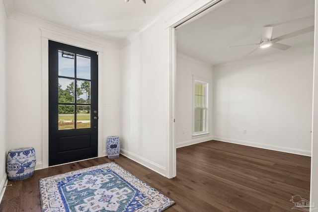 doorway to outside with dark wood-type flooring, crown molding, and ceiling fan