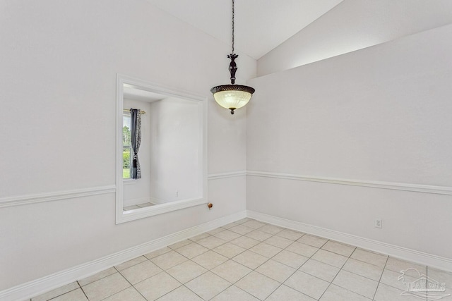 unfurnished room featuring light tile patterned floors, baseboards, and vaulted ceiling