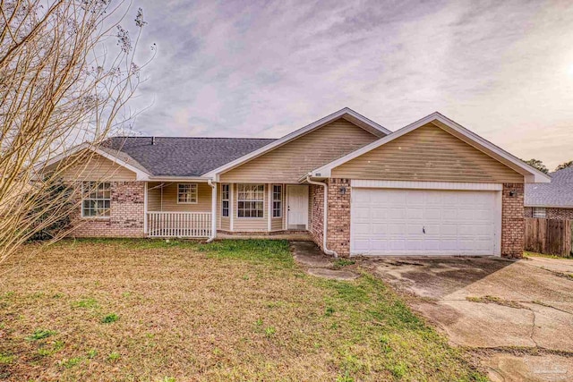 single story home with a garage and a lawn