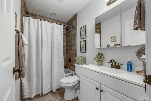 full bath featuring vanity, wood finished floors, a textured ceiling, toilet, and shower / tub combo with curtain
