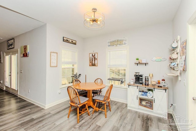 dining area featuring a chandelier and light hardwood / wood-style floors