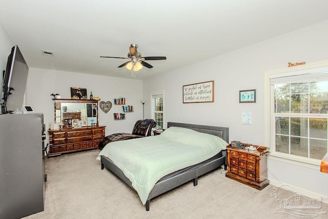 bedroom featuring ceiling fan and light carpet