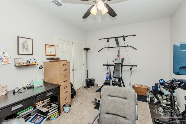 exercise area with ceiling fan and light colored carpet