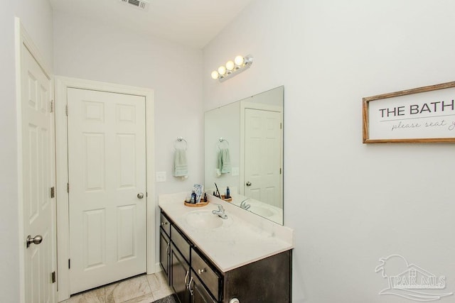 bathroom with tile patterned flooring and vanity