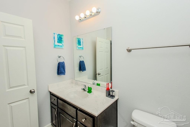 bathroom with toilet and vanity