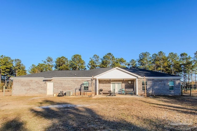 back of house with a patio area and a lawn