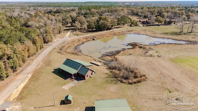 drone / aerial view featuring a water view and a view of trees