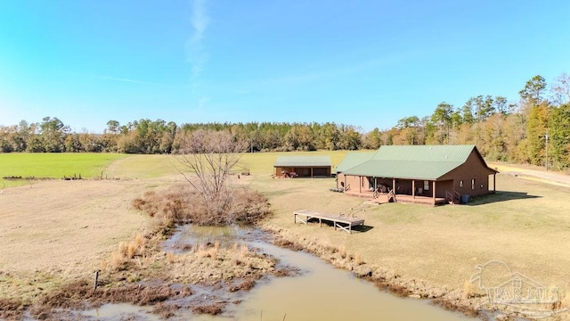 birds eye view of property featuring a wooded view and a rural view