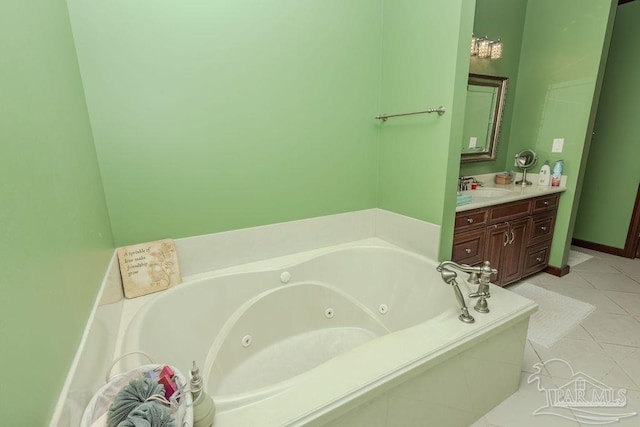 full bath featuring a whirlpool tub, vanity, and tile patterned floors