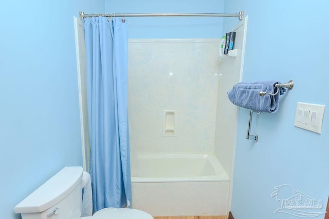 bathroom with toilet and shower / tub combo with curtain